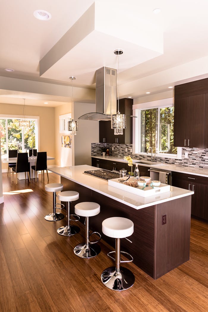services-02 Stylish kitchen featuring an island, bar stools, and contemporary decor.